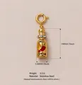 Golden stainless steel hot sauce bottle pendant with chili pepper enamel and rhinestones. - Spicy Bottle Pendant
