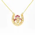 Exquisite gold horseshoe pendant necklace with intricately set pink floral details - January Carnation Horseshoe Necklace