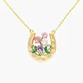 Close-up detail of a gold horseshoe necklace with colorful enamel flowers and crystals - April Sweet Pea Horseshoe Necklace