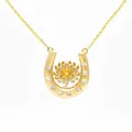 Detailed view of a gold horseshoe necklace with a yellow floral gemstone centerpiece. - November Chrysanthemum Horseshoe Necklace