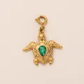 Detail of a golden sea turtle charm with a pear-cut green gemstone and sparkling crystals - Tortoise Pendant