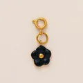 Macro view of black enamel flower pendant with 18K gold-plated spring ring clasp. - October Flower Pendant