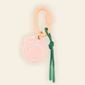 Close-up of a pink peach pendant charm with a green rope for bag decoration - Peach