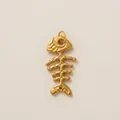 Detailed view of a gold-plated fishbone pendant with intricate skeletal textures. - Fishbone Pendant / 20x40mm Pack / Gold