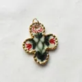 Close-up of a vintage floral pattern quatrefoil pendant with elegant gold scalloped edges. - Clover Pendant