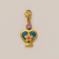 Detailed view of a gold-plated stainless steel heart-shaped charm with blue glitter - Blue Heart Pendant