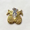 Close-up detail of a gold stainless steel pendant featuring mermaid and wing motifs. - Fish Tail Portrait Pendant