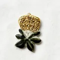 Unique artistic ceramic and gold-toned pendant featuring a minimalist face and leaf design. - Lotus Portrait Pendant