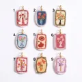 Catalog showing nine ceramic floral pendants with rose and tulip designs in gold frames - Pendant Only (No Chain) / Red Bottled Flower