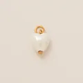 Detailed view of a white pearl-finish heart pendant featuring a gold-tone loop connector. - Heart Shell