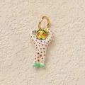 Detailed view of a whimsical colorful character pendant with polka dots and gold ring. - Muscle Man Pendant