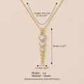 Detailed view of gold-toned heart crystal pendant with copper necklace specifications - Heart Row Zircon Layered Necklace / Gold