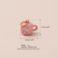 Miniature pink mug charm made of stainless steel featuring a white bow and gold ring - Pink Cup With Bow Pendant / Pink