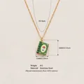 Close-up of vintage stainless steel book pendant necklace with mushroom print. - Hand-painted Book Necklace (HSNK253806K) / Green Mushroom