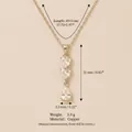 Elegante Halskette aus Kupfer mit facettierten Herz- und Tropfenanhänger-Details - Drei-Herz-Dangle-Stil / Gold