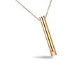 Close-up shot of a minimalist rose gold whistle pendant necklace made of durable titanium steel - Breathing Whistle Gold 60cm