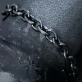 Macro view of hip-hop men's black stainless steel NK Cuban chain bracelet with matte finish - Angular Curb Link / Black