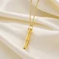 Macro shot showing the intricate details of a golden whistle pendant on satin background. - Rotating Bead Gold Slim Waist Necklace