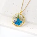 Elegant gold plated resin pendant necklace featuring real blue dried flowers inside - March