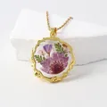 Gold-plated necklace featuring a round resin pendant with real pressed purple flower petals - November