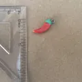 Close-up detail of a small red chili pepper pendant with ruler for size reference - Chili Pendant Only (Without Chain)