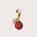 Close-up of handmade jewelry charm with red disc bead and pink round bead - Red Round Enamel Pendant / Red