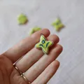 Handcrafted yellow ceramic four-point star pendant with blue floral design - 16 Small Flower Pendants