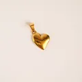 Detailed macro shot of a polished gold-plated stainless steel heart-shaped pendant - Slanted Heart Pendant
