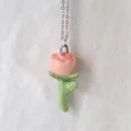 Macro detail of a pink rose pendant with green leaves and drip oil enamel finish. - Daisy Flower Pendant