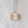 Close-up view of a minimalist ceramic-style book-shaped pendant on a silver chain - Book Charm