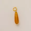 Detail showing a minimalist gold hoop with a yellow faceted teardrop pendant accessory. - Teardrop Shape (YKXS260412175GK) / 12mm Wide / Yellow