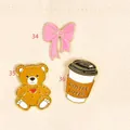 Collection of enamel pins featuring a pink bow, a teddy bear, and a coffee cup pin. - Coffee Cup Style(36)