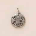 Macro detail of Promoted to Mommy engraved silver stainless steel round pendant charm - Inspirational Round Tag