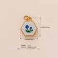 Hexagonal stainless steel charm with blue floral print in gold finish. - Polygonal Light Blue Small Flower Pendant