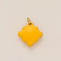 Detail view of a bright yellow wavy-edged stainless steel charm for DIY jewelry - Sun Pattern