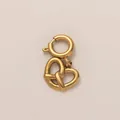 Macro view of a 18K gold-plated heart pretzel pendant with a spring ring clasp - Bread