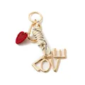 Detail of a fashion keychain featuring gold LOVE letters and a red embroidered heart charm. - LOVE Letter Style