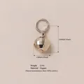 Textured faceted copper sphere pendant for DIY jewelry making shown on beige background - 4 Silver Ball Pendant
