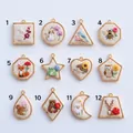 Detailed view of 12 animal embroidery pendants in various geometric gold frames - Rabbit Embroidery Pendant (1)