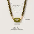 Detail of olive green beaded necklace with zircon evil eye pendant and measurements. - Yellow