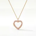 Primo piano dettagliato di una collana a medaglione a cuore con smalto rosa e cristalli - Collana Medaglione Cuore Strass Rosa / Oro