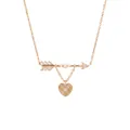 Detailed macro shot of a gold Cupid's arrow necklace with white pearls and heart pendant. - Cupid Arrow Heart Necklace
