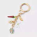 Detailed view of a 18K gold-plated keychain with chili, lemon, and bow charm detail. - Fruit Butterfly Style