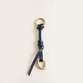Close-up of vintage navy leather bag charm with distressed brass metallic rings - Navy Blue Leather Metal Ring Charm / Navy Blue