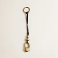 Macro detail of vintage leather strap bag charm featuring antique brass finish metal pendants - Black Leather Oval Ring Charm / Black