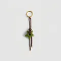 Detail of vintage braided cord keychain with green star charm and golden ring - Brown Rope Star Charm / Brown