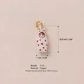 Macro detail of cute white doll charm with 16.8mm height and 7mm width dimensions. - White Humanoid Tumbler Pendant