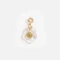 Detail of a creative resin fried egg pendant with a gold-plated stainless steel clasp. - Fried Egg Pendant / Gold Yellow