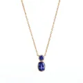 Macro view of gold bezel-set pendant with two oval and round blue natural stones - December Blue Rhinestone (Gold)