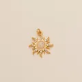 High-detail macro view of a gold sun pendant featuring a central opal stone inlay - Sun Opal Rhinestone Pendant